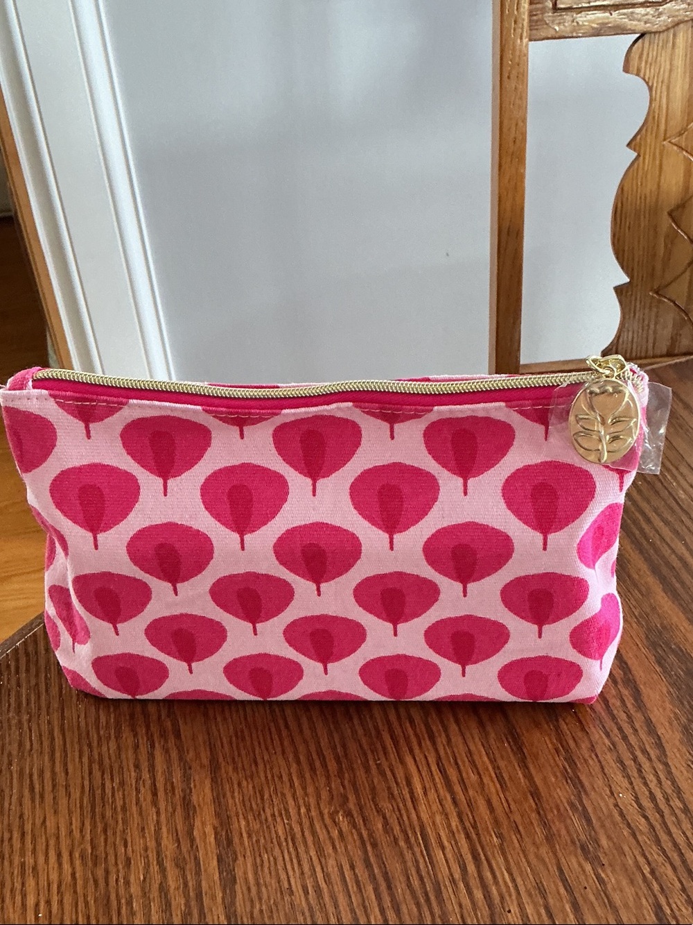 Estée Lauder "Beauty in Bloom" makeup bag featuring a pink and white leaf patter